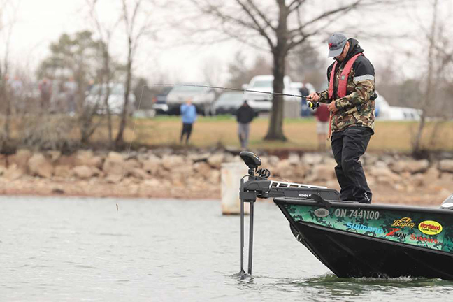 Jeff Gustafson fishes from boat in lake