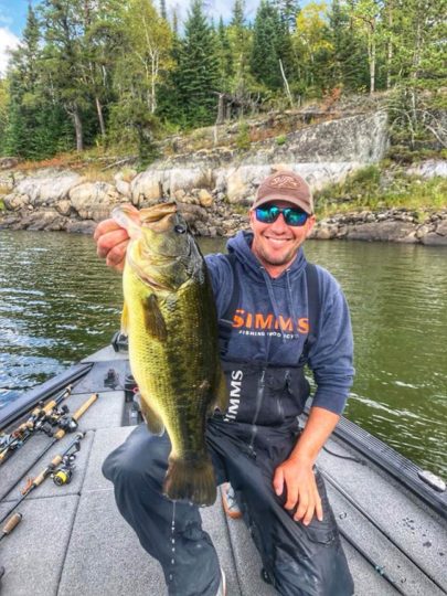 Jeff holds fish in a boat