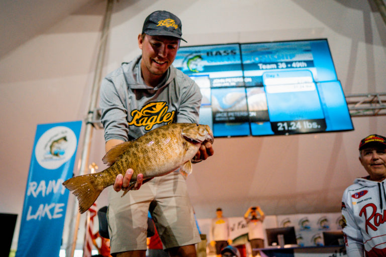 Jace Peterson holding a smallmouth bass at the weigh in