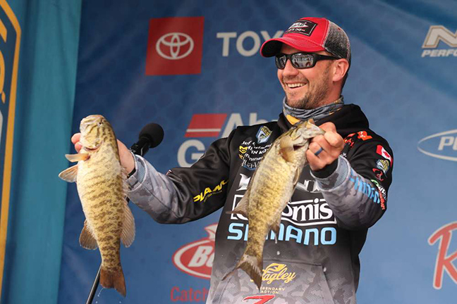 Jeff Gustafson holding two bass