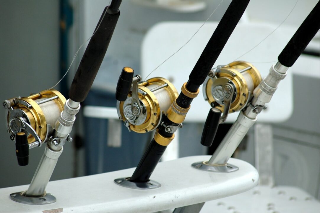 3 fishing rod spools sit on mounts